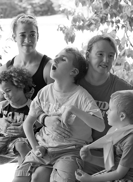 Three kids and two moms sitting together