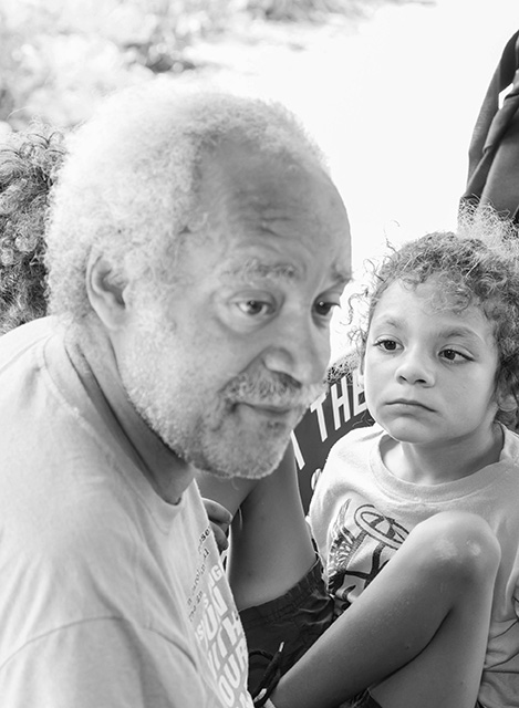 Older man next to a younger girl looking sideways